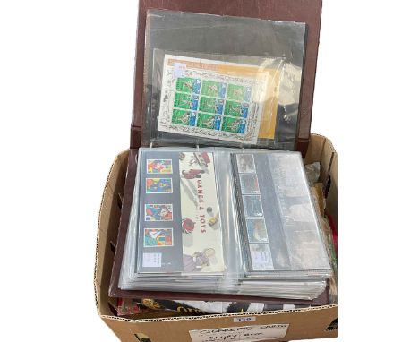 Leatherette album of stamp presentation packs, cigarette cards, tea cards, etc.