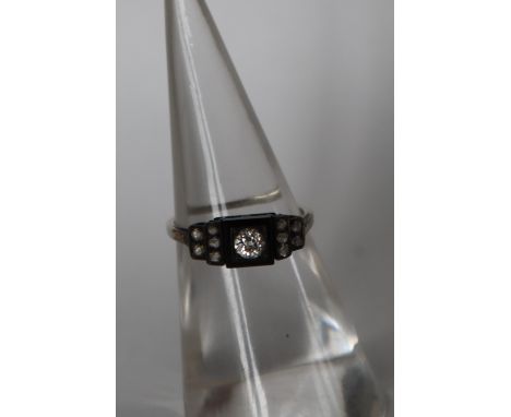 A diamond and onyx ring, set with a central old round cut diamond approximately 0.10cts to a square onyx panel with ten rose 