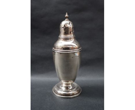 A George V silver sugar caster with a vase finial and domed cover with a tapering beaded body on a spreading foot, Birmingham