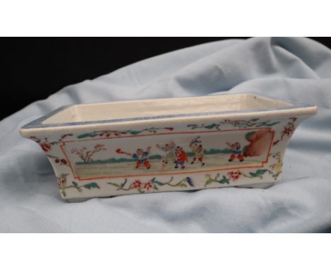 A Chinese porcelain planter of rectangular form with vignettes depicting children playing and flowers to a floral border on s