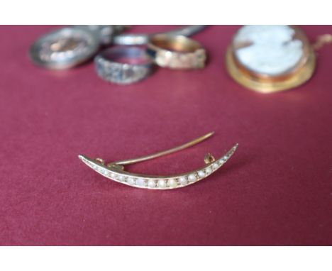 A yellow metal seed pearl crescent brooch, together with a cameo brooch, silver medallion, silver hinged bangle and two rings