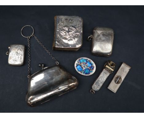 An Elizabeth II cigar cutter together with a Sterling Silver cigar cutter, silver purse, silver vesta case, silver backed com