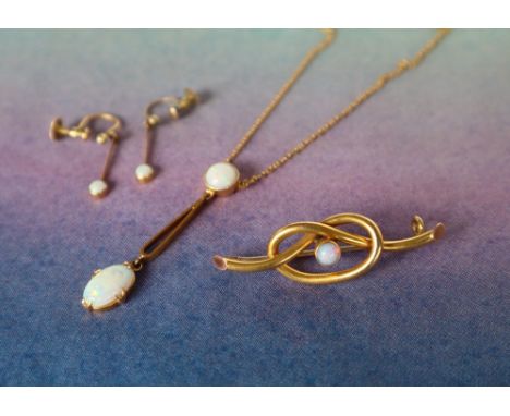 A 9ct gold opal set pendant on a 9ct gold chain, together with a matching bar brooch and a pair of earrings, approximately 5.