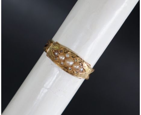 A Victorian 15ct gold mourning ring set with half pearls and diamond chips, only traces of the black enamel remains, size P 1