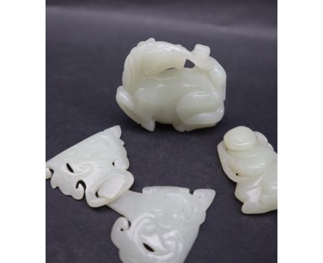 A Chinese "jade" hardstone carving of a horse with a monkey on its back, together with a carved figure and a two piece buckle