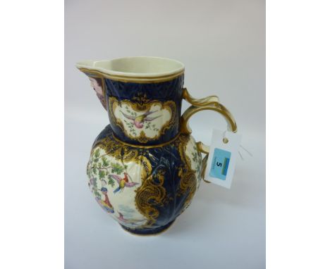 First Period Worcester porcelain jug, scale blue cabbage leaf moulded body with mask-head spout, cartouches painted in polych