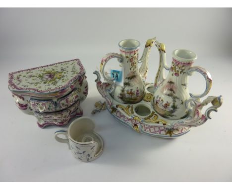 Early 20th century French faience cruet set and stand, similar four drawer bombe commode chest and a Portuguese chamberstick 