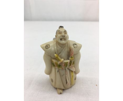 A fine Japanese carved ivory netsuke depicting Samurai warrior Okubo Hikozaemon (1553-1628), signed to the base and depicting