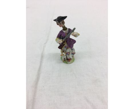 A 19th century German  ceramic perfume bottle depicting figure of a lady with a gun and dog