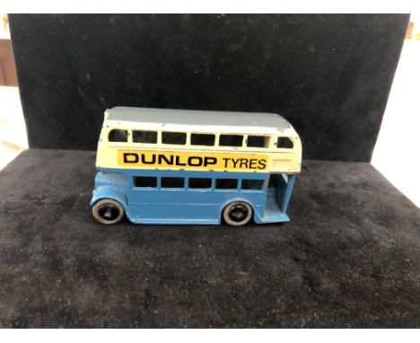 A pre-war Dinky bus with staircase and 'Dunlop tyres' in blue