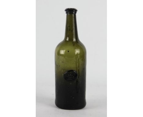 An early 19th green glass seal bottle, the front applied with a seal depicting a Welsh dragon on a armorial cushion, possibly