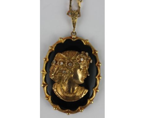 A 9ct portrait pendant London 1974, the oval pendant depicting a lady's portrait on profile with stone set headdress on an on