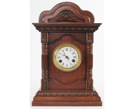 A late 19th century carved oak eight day bracket clock, enamel Roman numeral dial and movement signed for J Unghans Wurttembe
