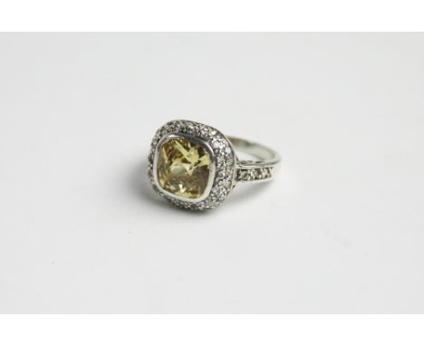 A citrine set dress ring, designed as a central cushion shaped citrine, within further stone set surround, all set in white m