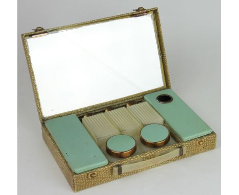 A Sirram 1960's vanity case, the shagreen effect case enclosing a fitted interior with mirrored lid, complete with three bott