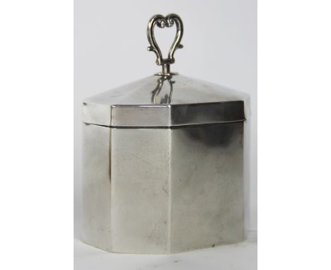 A silver tea caddy, Stokes and Ireland Ltd, Chester 1918, of octagonal form and with heart shaped, loop handle, 11cm high, we