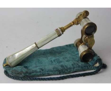 A pair of French lacquered brass and mother of pearl opera glasses, in lace lined velvet case, 15.5cm
