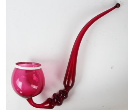 A 19th century cranberry glass pipe, with opaque rim, 48cm long