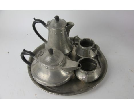An Arts and Crafts pewter five piece tea set, with faux riveted and hammered decoration, tray 32cm