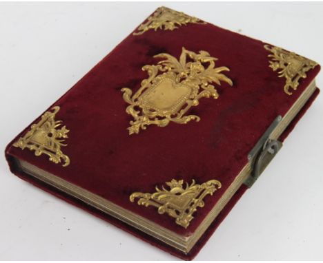 A Victorian photograph album, the velvet covered album with gilt metal mounts, containing landscape decorated views and portr