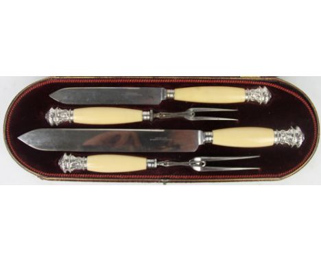 A Victorian silver mounted ivory four piece carving set, each terminal modelled with a rams head, Harrison Brithers & Howson,