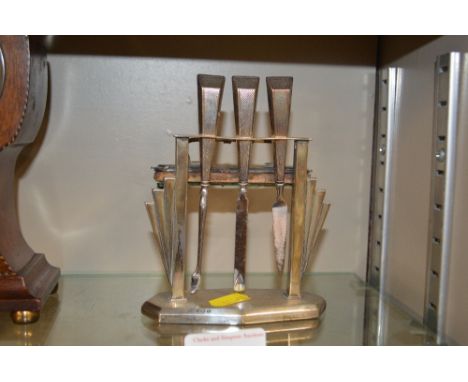 An Art Deco silver manicure set on stand, with engine turned decoration 