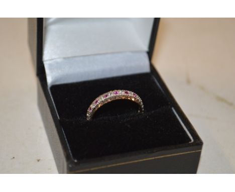 A 9ct gold white stone and ruby set eternity ring