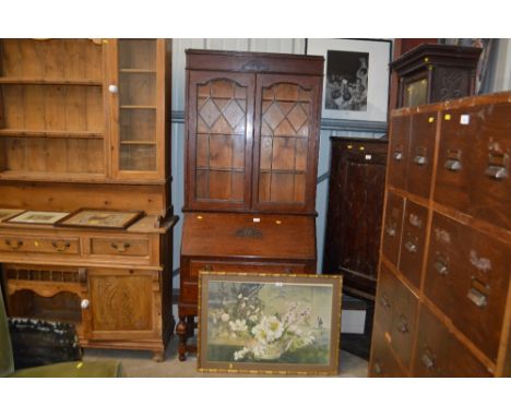 An oak and leaded glazed bureau bookcase fitted two long drawers 