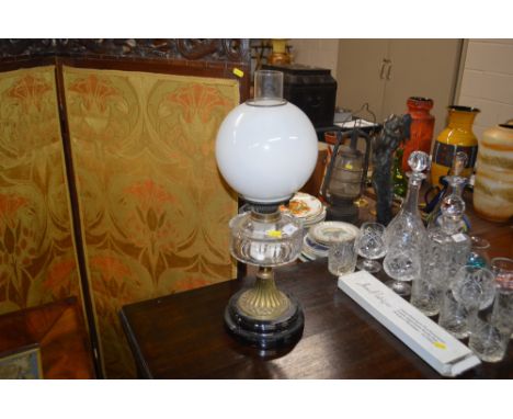 A brass and glass oil lamp with clear glass reservoir 