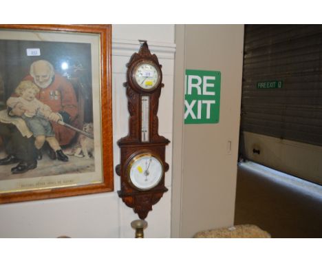 A carved oak barometer 