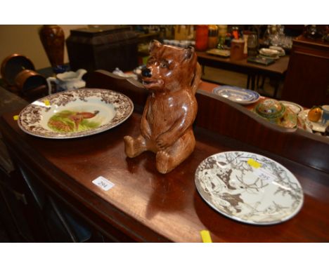 A Spode pheasant plate; a brown glazed pottery mug in the form of a seated bear; and a 1976 Irma saucer plate by Louis Rosen 