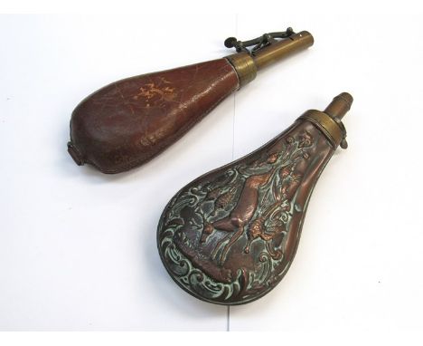 A Victorian embossed copper powder flask, hunting scene (dented) and a brown leather shot flask (2)