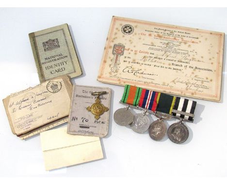 A medal group of four consisting of WWII Defence and war medals, EIIR Territorial Efficiency medal and Order of St John Servi