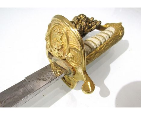 An EIIR British Naval officer's sword, the gilded brass basket with anchor and crown, lion pommel and rayskin grip, the blade