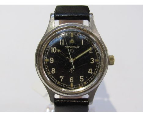A mid 20th Century Hamilton military wristwatch with black face and Arabic numerated dial, wind-up mechanism, broad arrow wit