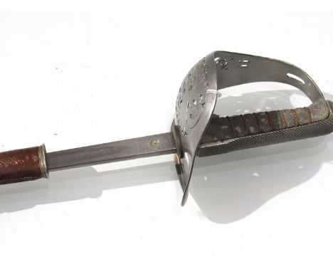 An 1897 pattern infantry officer's sword, King Edward VII engraved blade, maker indistinct, with brown leather scabbard 