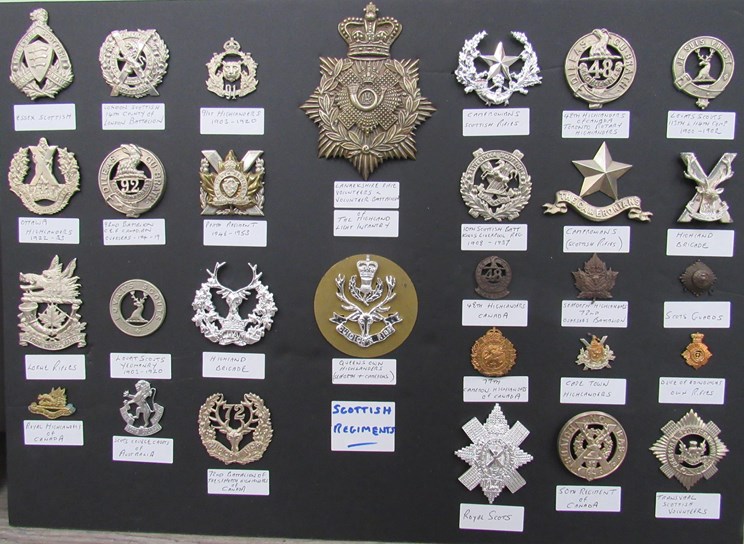 A collection of Scottish Regiment badges mounted on board including ...