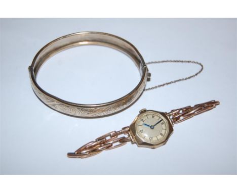 A ladies 9 ct gold cased wristwatch with manual wind movement and gold plated silver hinge bangle (2)