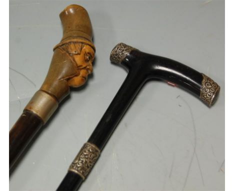 A late Victorian ebony and silver mounted walking stick together with another (2)