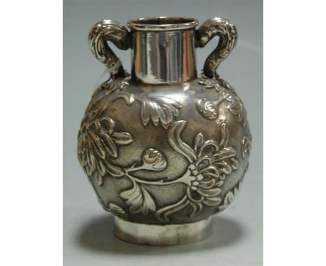 A small late 19th century sterling silver vase of squat form relief decorated with flowers and foliage