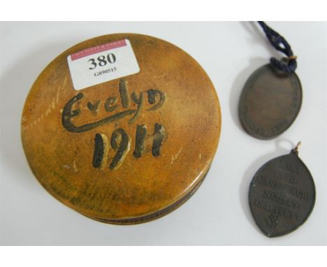 A Victorian bronze nursing medal and another similar in turned wooden box 