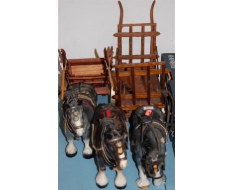 A Melba figure of a Shire horse; together with two others, each pulling carts (3)