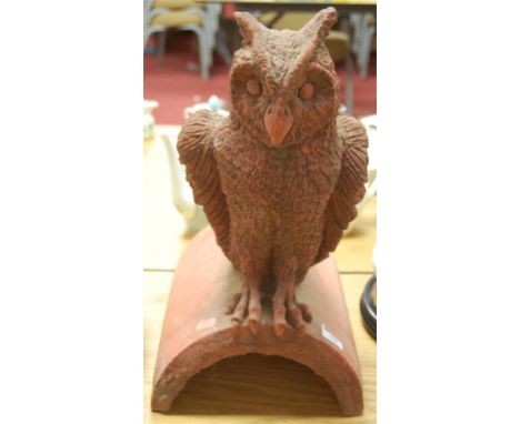 ***CHANGE TO CATALOGUE*** A PAINTED CONCRETE ridge tile surmounted by a bird
