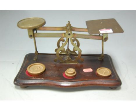 A set of brass postage scales and weights