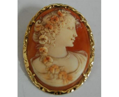 A carved shell cameo brooch depicting profile portrait of a maiden in a yellow  gold mount