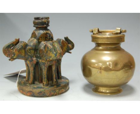 An Eastern brass vessel, together with an Indian style painted figural candlestick 