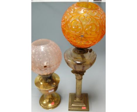 A Victorian brass pedestal oil lamp, having cut glass reservoir, and one other later lacquered brass example (2)