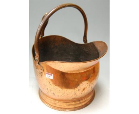 A 19th century copper helmet shaped coal scuttle 