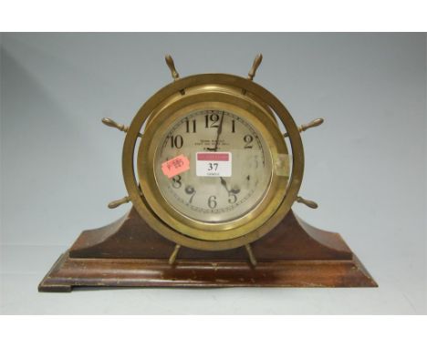 A Seth Thomas brass cased ships wheel mantel clock 