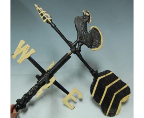 A cast iron weather vane surmounted by a cockerel Condition Report / Extra Information NSEW Dia. 30cm. Arrow. 49cm.
Rotates w